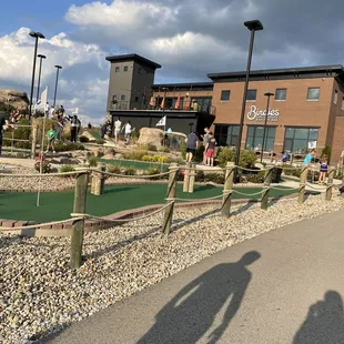 people playing miniature golf