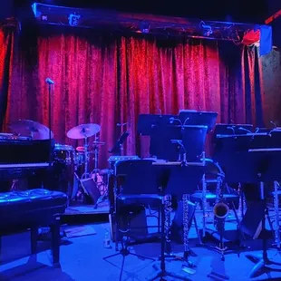 a stage with musical instruments and a piano