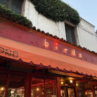 a restaurant with red awning and red awning