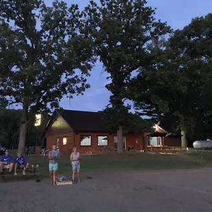 a group of people standing in front of a cabin