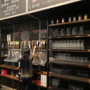 a woman filling up a beer