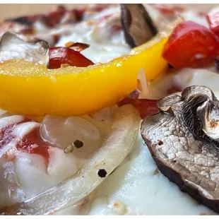 a pizza with mushrooms and peppers