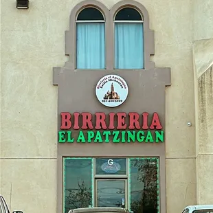 cars parked in front of a restaurant
