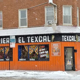 an orange building on a snowy day