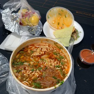 a bowl of pasta with meat and vegetables