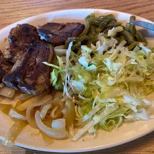 These are SUPPOSED to be lamb chops. They were so over cooked they looked burnt. And this was the extra  "salad" they gave her.