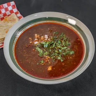 a bowl of chili and tortilla