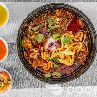 a bowl of ramen and sauces