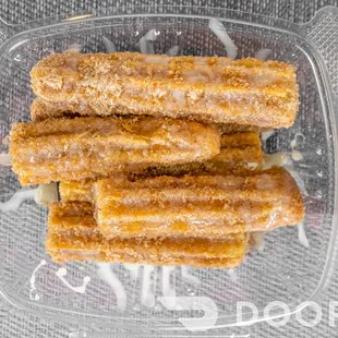 a close up of a box of churros