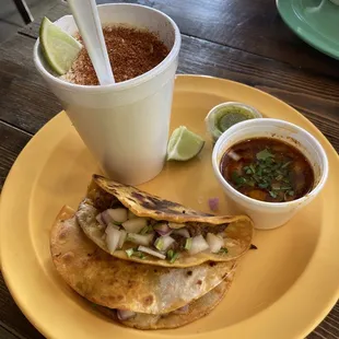 Two birria tacos and a serving of elote