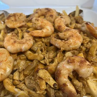 Cowboy fries. It's grilled shrimp and chicken tossed in buffalo sauce on top of French fries and cheese finished off with sour cream