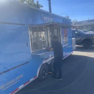 a man standing in front of a food truck