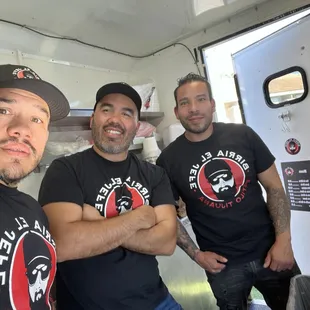 three men in a food truck