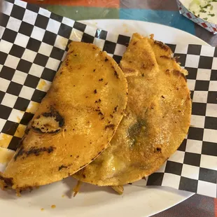 two quesadillas on a checkered plate