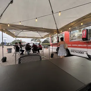 a woman ordering food from a food truck