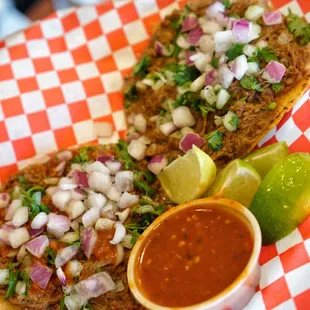 two tacos on a red and white checkered plate