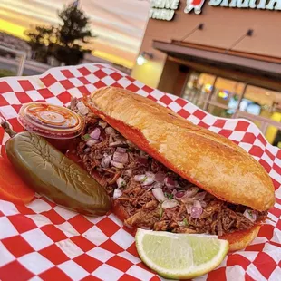 a pulled pork sandwich with a pickle