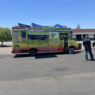 a man standing in front of a food truck