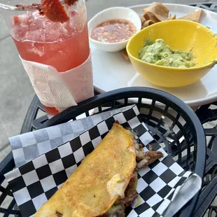 Cheese birria quesadilla, fresh guacamole, chips, salsa and a strawberry margarita made with real strawberries.