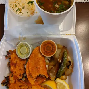 a bowl of soup, tortillas, and a bowl of soup