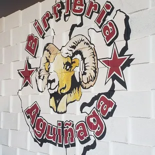 a ram head on a brick wall