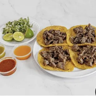 a plate of beef tacos and salsa