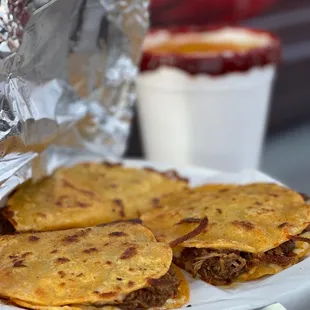 a person holding a plate of quesadillas