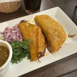 Birria beef taco and carnitas taco