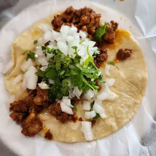 Taco de Adobado made with fresh hand padded tortilla