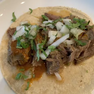 beef and onions on a tortilla