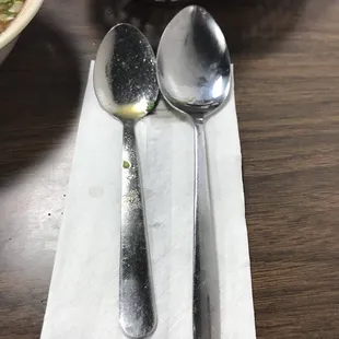 two spoons and a bowl of soup