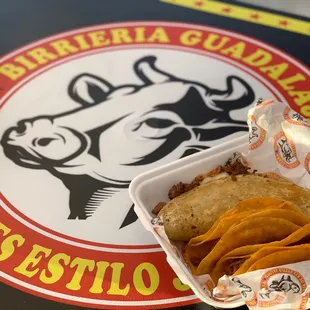 a taco and chips in a styrofoam container