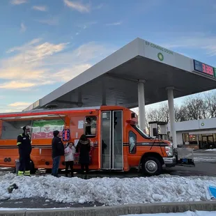 a group of people getting on a bus