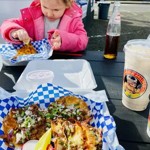a little girl eating a meal