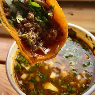 Taco de birria with delicious consome in portland oregon