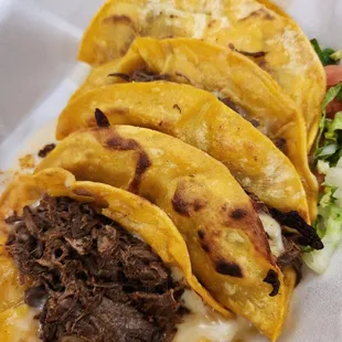 three tacoss in a styrofoam container