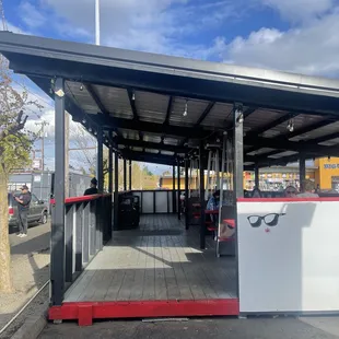 Legit covered outdoor seating area.  Solid wood structure with 5 picnic tables