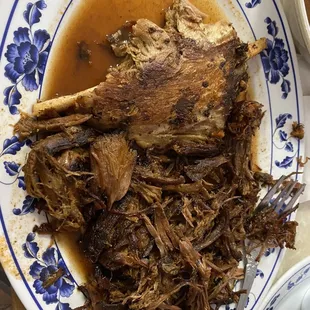 a plate of meat with gravy