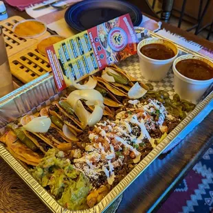 Birria pack with asada fries and consome.  Not shown but included was churros and soft serve dessert