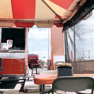 a table and chairs under an umbrella