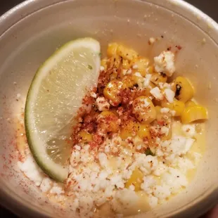 Esquites elotes w/onion, serrano, chile guajillo aioli and queso cotija. Delicious.