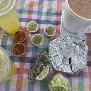 Pineapple agua fresca and birria plate (comes with tortillas, chopped cabbage, radishes, onions, and limes)