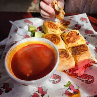 Birria sliders with consomme.