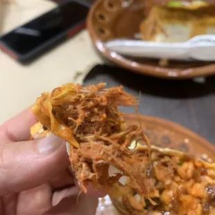 a person holding a piece of food