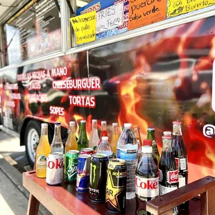 A variety of bottled beverages on top of their daily fresh Agra frescas