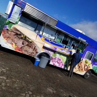 a man standing in front of a food truck