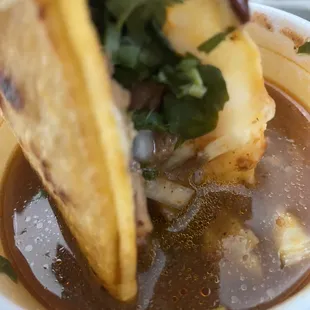 Birria de chivo taco w cheese &amp; consomé on the side
