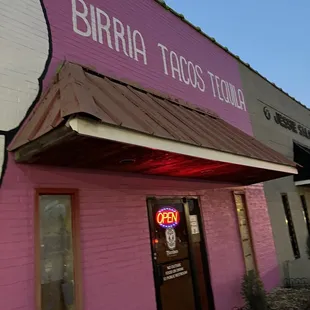 a pink building with a hello kitty sign