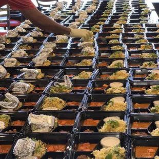 a table full of trays of food