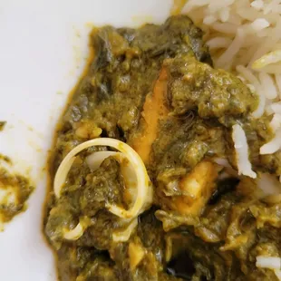 a plate of food with rice and spinach